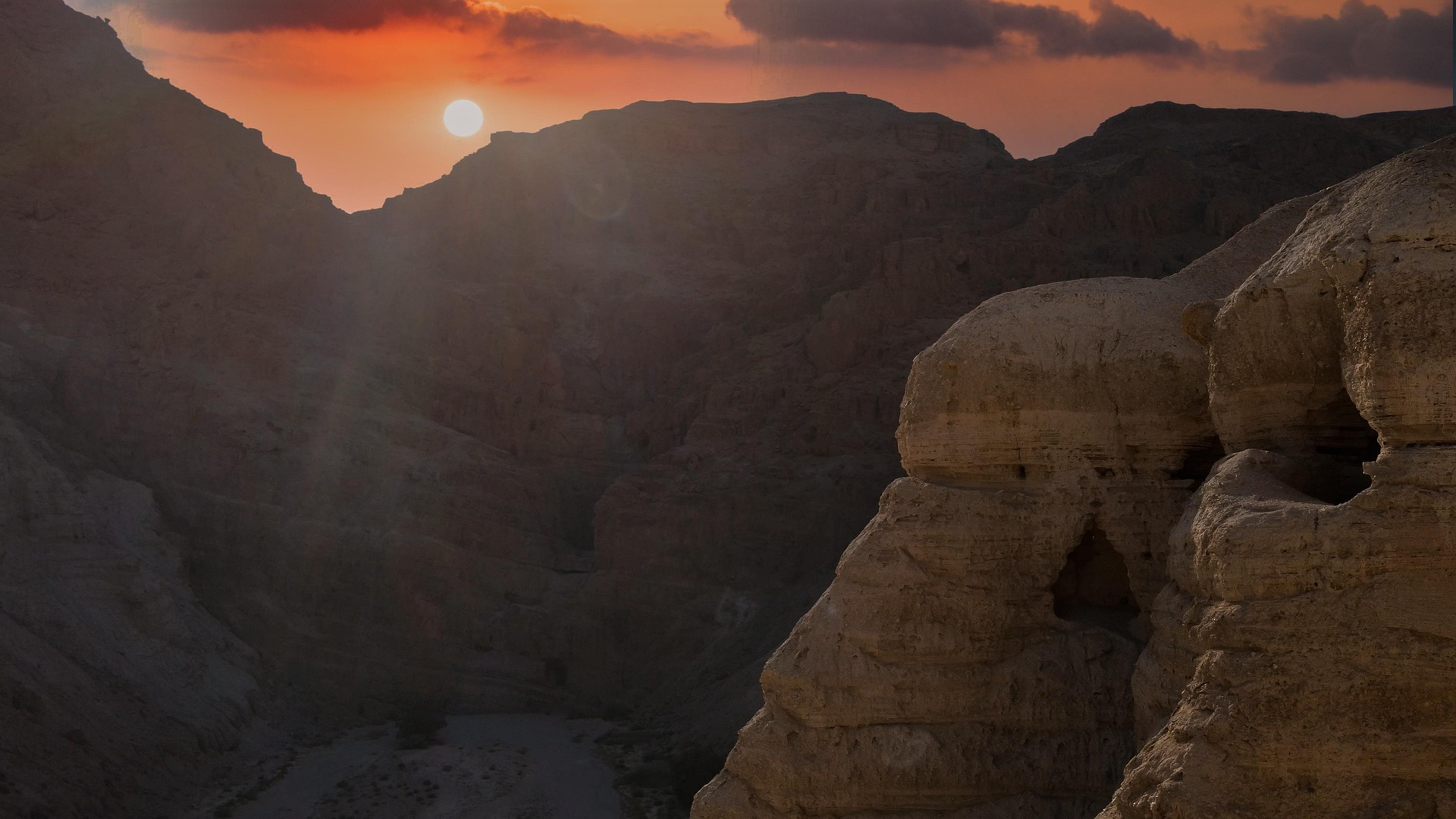 Qumran caves at sunset in the Judean Desert